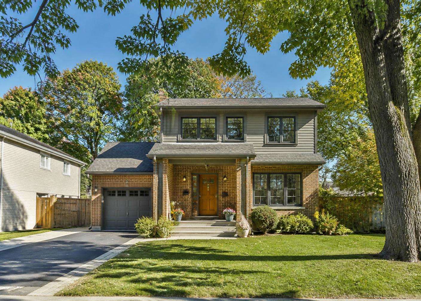 Street view of a two-storey Ottawa home with a second-floor addition